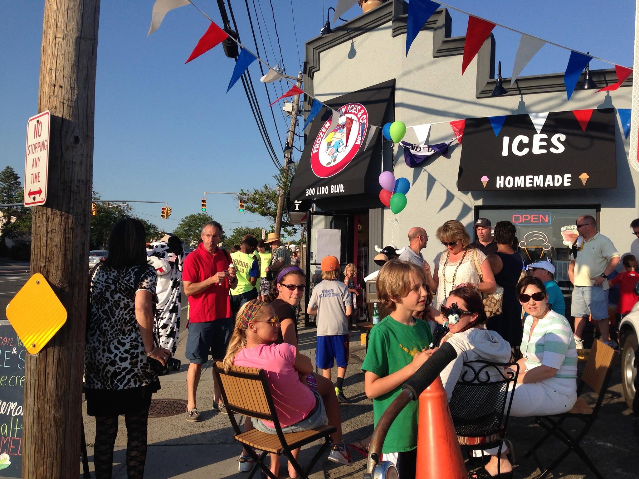 Frozen Cow Ices & Cream storefront at 300 Lido Boulevard with customers outside